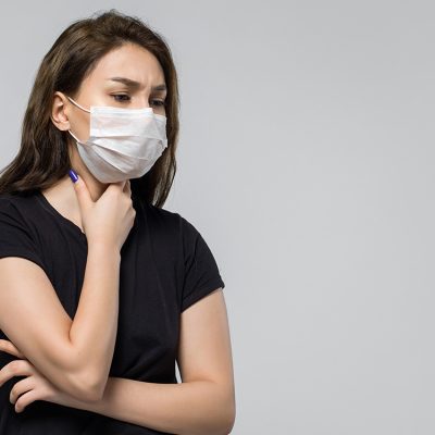 woman-wearing-black-t-shirt-medical-protective-mask-feeling-sick