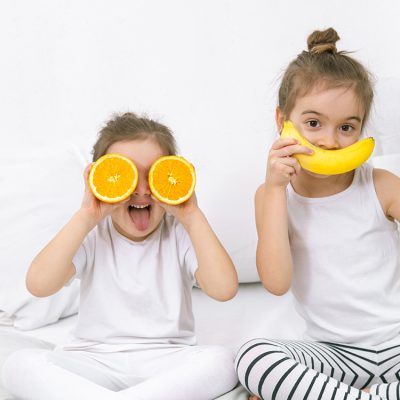 happy-two-cute-children-playing-with-fruits-vegetables
